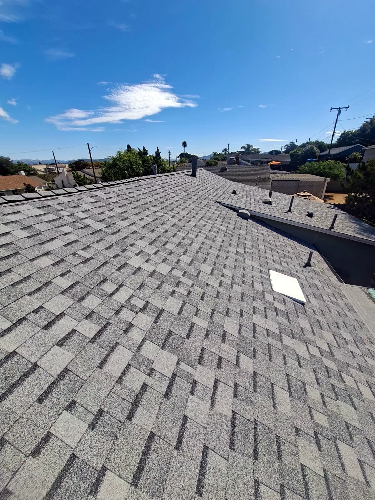 Owens Corning Sierra Gray shingle roof in Camarillo, CA with skylight and hillside view