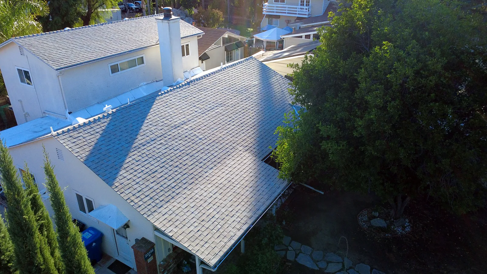 New light gray shingle roof with chimney on a Woodland Hills home, aerial view