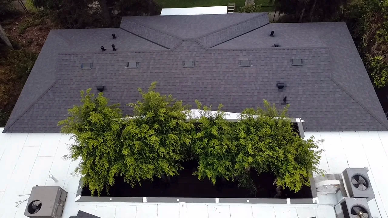 Hip roof with new dark architectural shingles and vents above the courtyard, Barrington, West LA